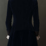 Woman wearing a long embroidered velvet jacket