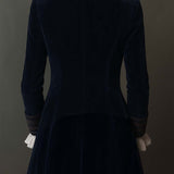 Woman wearing a long embroidered velvet jacket