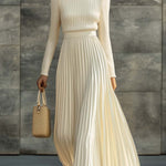 Woman wearing a knitted satin dress with pleated skirt
