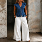 Woman wearing a sleeveless V-neck denim top