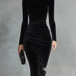 Woman wearing a black velvet fitted dress