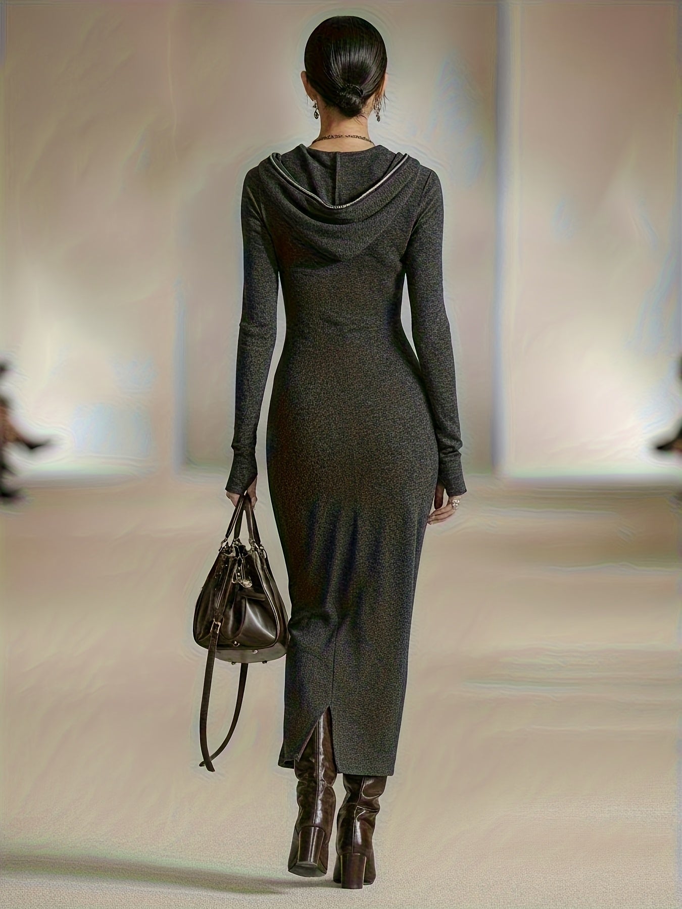 Woman wearing a long-sleeve hooded tunic dress with zip detail