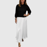Woman wearing a maxi dress with a knit-look bodice and pleated skirt