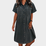 Woman wearing a lightweight denim button-through shirt dress