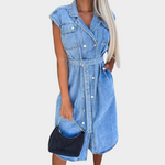 Woman wearing a sleeveless denim dress with a matching belt