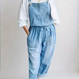 Woman wearing a loose-fit denim jumpsuit in a classic wash