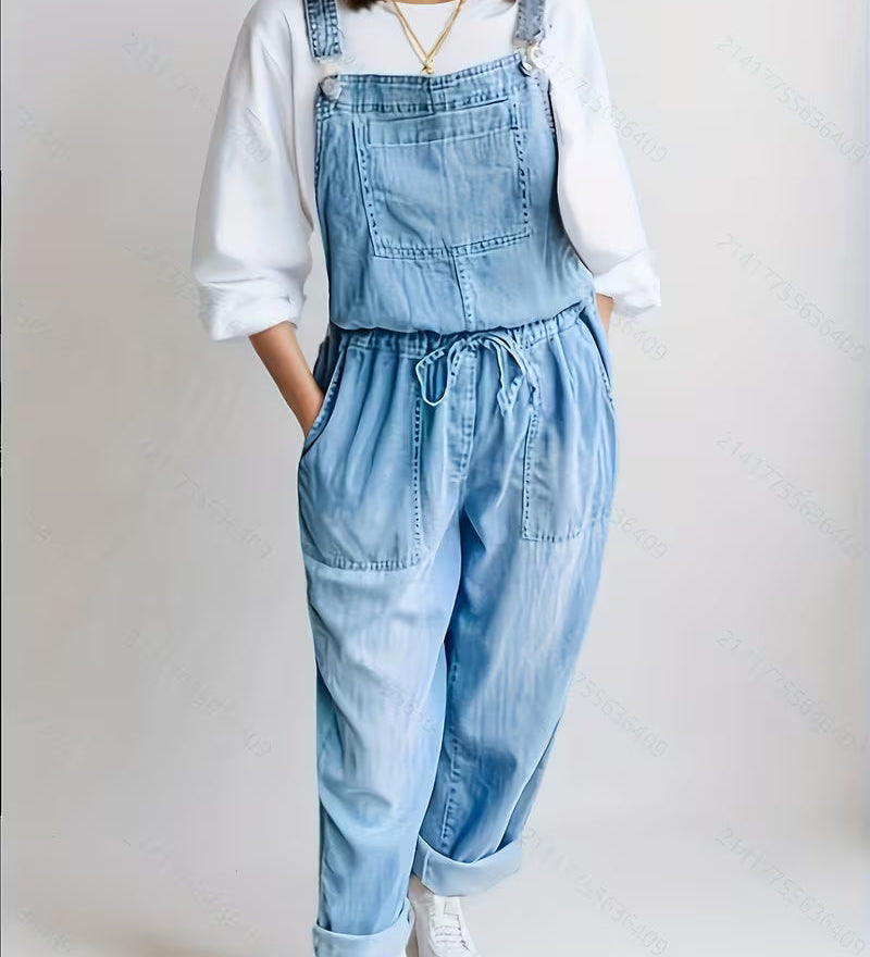 Woman wearing a loose-fit denim jumpsuit in a classic wash