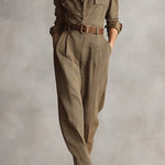 Woman wearing a tailored check jumpsuit with belt