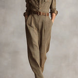 Woman wearing a tailored check jumpsuit with belt