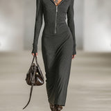 Woman wearing a long-sleeve hooded tunic dress with zip detail