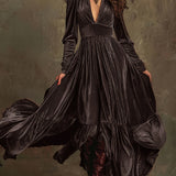 Woman wearing a deep V-neck pleated maxi dress