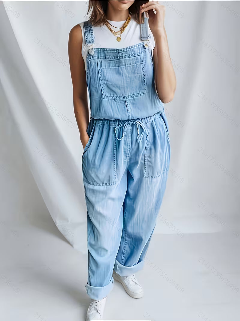 Woman wearing a loose-fit denim jumpsuit in a classic wash