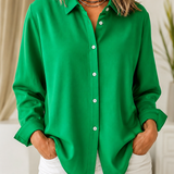 Woman wearing a blush pink relaxed button-front blouse