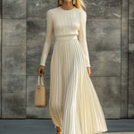 Woman wearing a knitted satin dress with pleated skirt