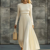 Woman wearing a knitted satin dress with pleated skirt