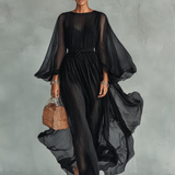 Woman wearing a statement sleeve pleated midi dress