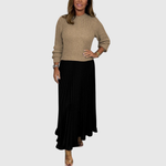 Woman wearing a maxi dress with a knit-look bodice and pleated skirt