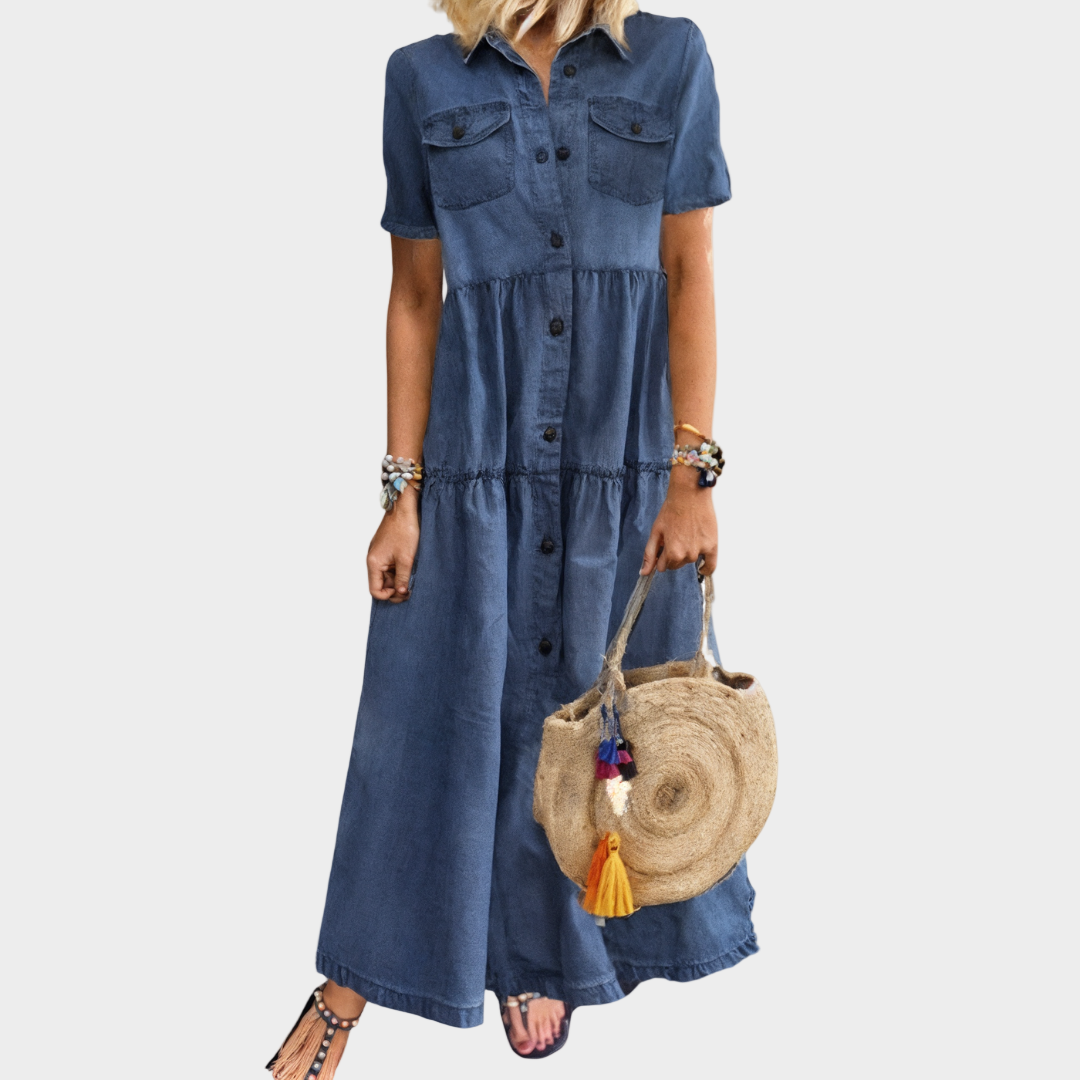 Woman wearing a long button-front denim dress with short sleeves