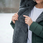 Woman wearing a fleece-lined quilted padded jacket with a shaped waist