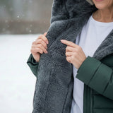 Woman wearing a fleece-lined quilted padded jacket with a shaped waist