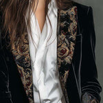 Woman wearing a long slim baroque print blazer