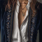 Woman wearing a long embroidered velvet jacket