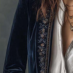 Woman wearing a long embroidered velvet jacket
