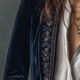 Woman wearing a long embroidered velvet jacket