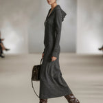 Woman wearing a long-sleeve hooded tunic dress with zip detail