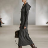 Woman wearing a long-sleeve hooded tunic dress with zip detail