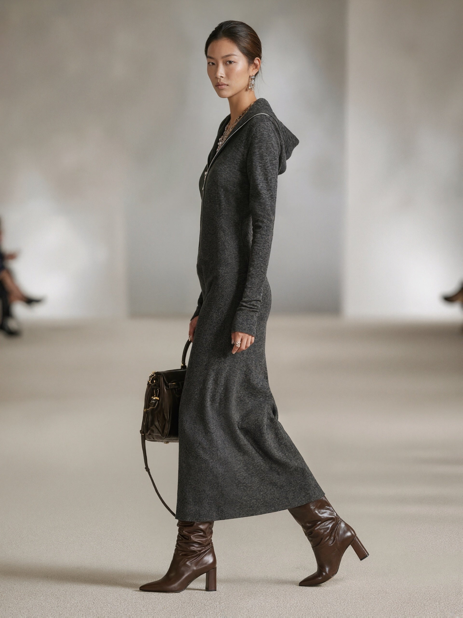Woman wearing a long-sleeve hooded tunic dress with zip detail