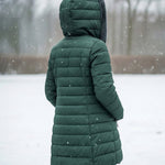 Woman wearing a fleece-lined quilted padded jacket with a shaped waist