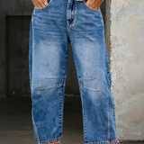 Woman wearing loose flare denim jeans with a flattering high-rise fit