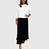 Woman wearing a maxi dress with a knit-look bodice and pleated skirt