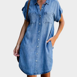 Woman wearing a loose-fit button-front denim dress