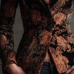 Woman wearing a black and bronze floral blazer