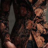 Woman wearing a black and bronze floral blazer