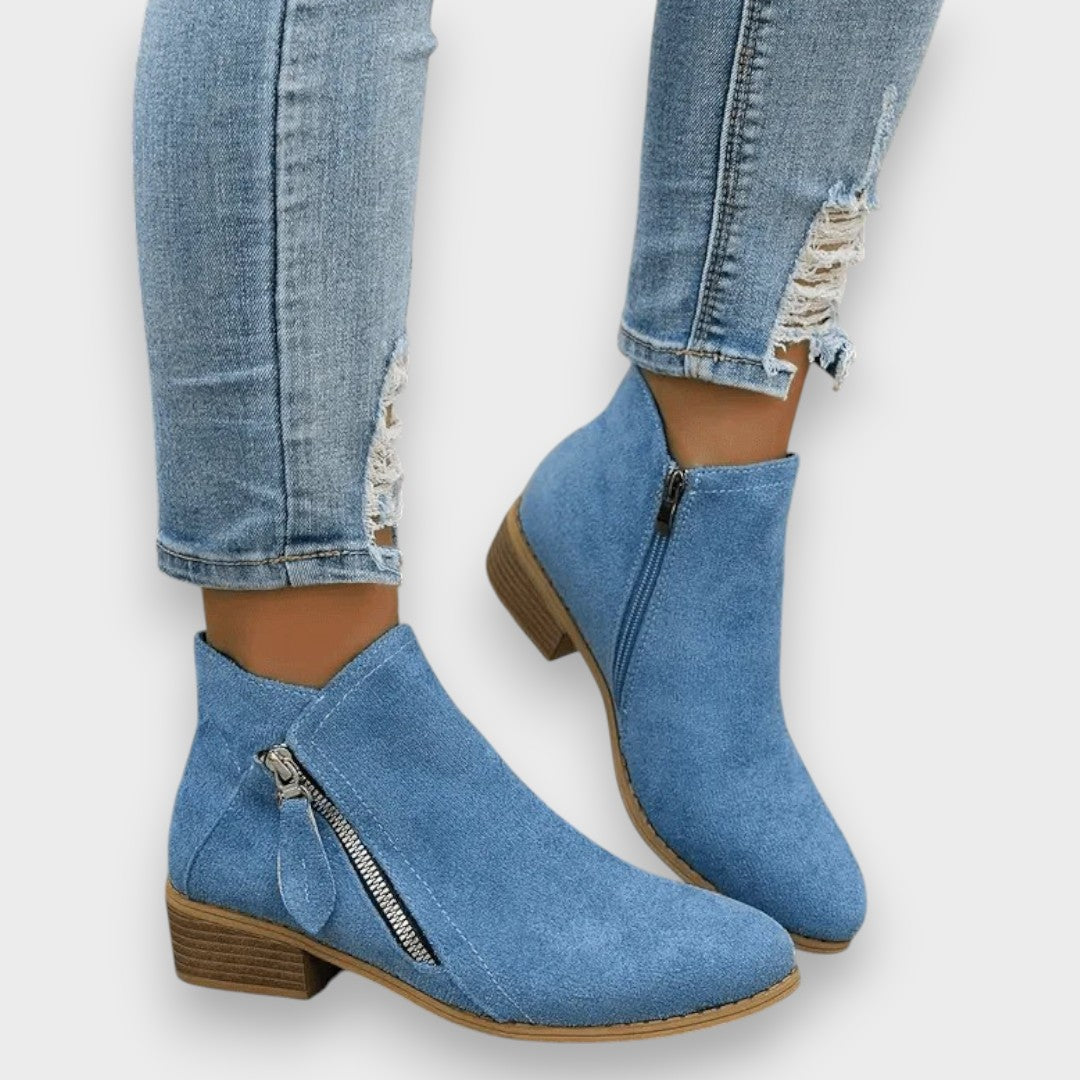 Elsie suede-look side-zip ankle boots in blue, side view with jeans