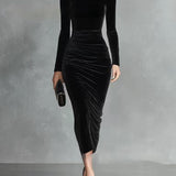 Woman wearing a black velvet fitted dress
