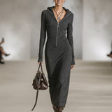 Woman wearing a long-sleeve hooded tunic dress with zip detail