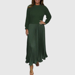 Woman wearing a maxi dress with a knit-look bodice and pleated skirt