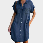 Woman wearing a loose-fit button-front denim dress