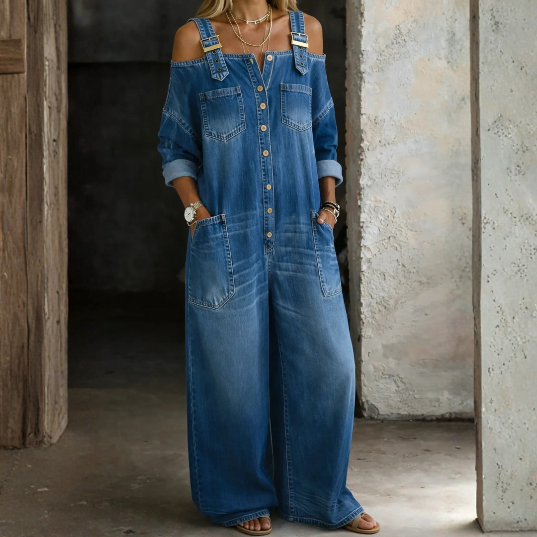 Woman wearing an off-shoulder denim jumpsuit in a classic wash
