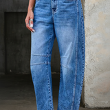 Woman wearing loose flare denim jeans with a flattering high-rise fit