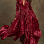 Woman wearing a deep V-neck pleated maxi dress