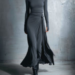 Woman wearing a long-sleeve maxi dress with an adjustable side tie