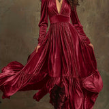 Woman wearing a deep V-neck pleated maxi dress