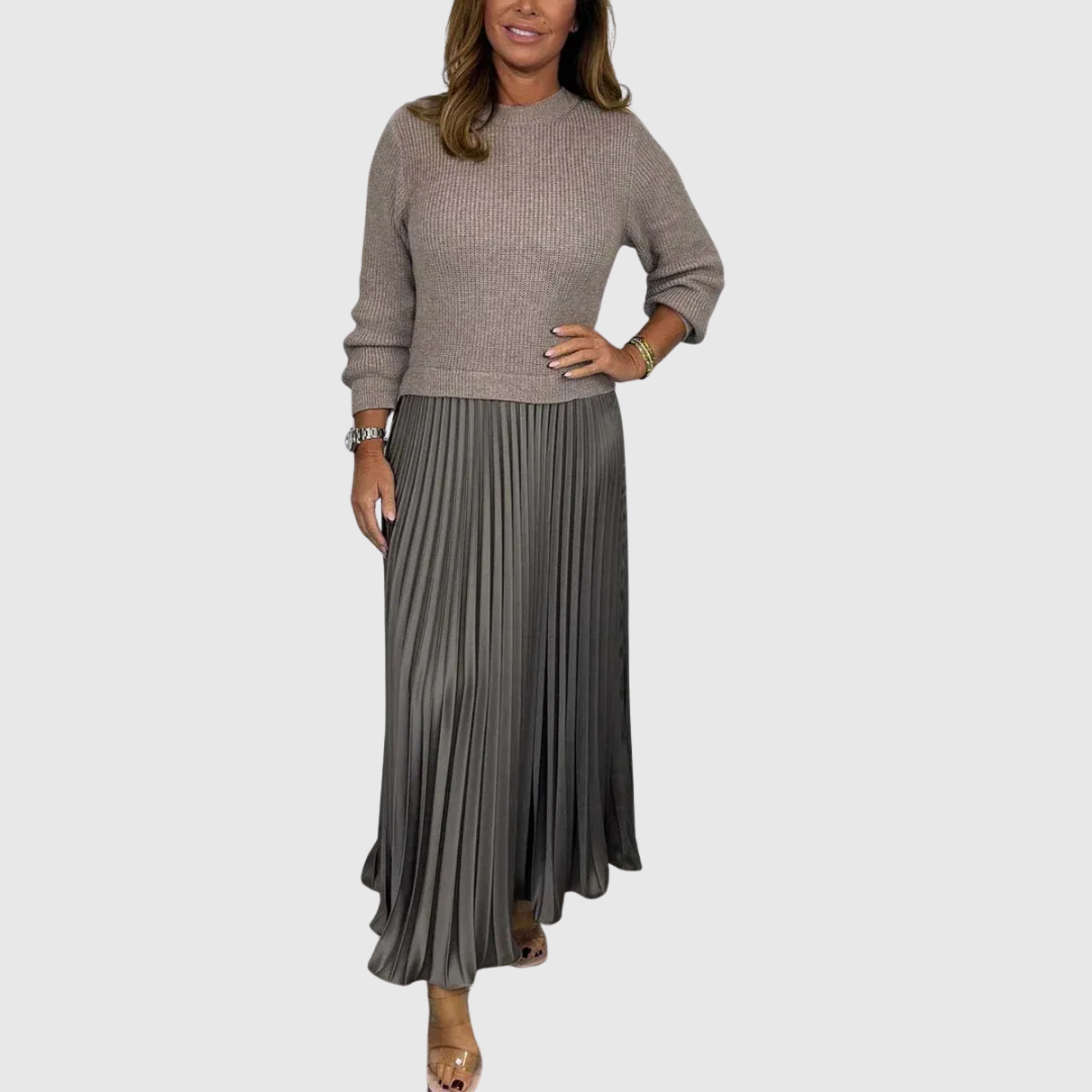 Woman wearing a maxi dress with a knit-look bodice and pleated skirt