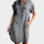 Woman wearing a loose-fit button-front denim dress