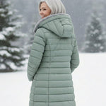 Woman wearing a fleece-lined quilted padded jacket with a shaped waist